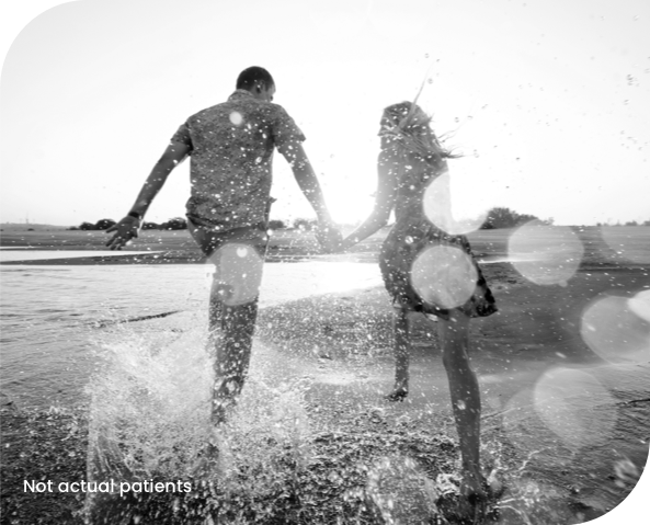 People playing in an inflatable pool in a yard